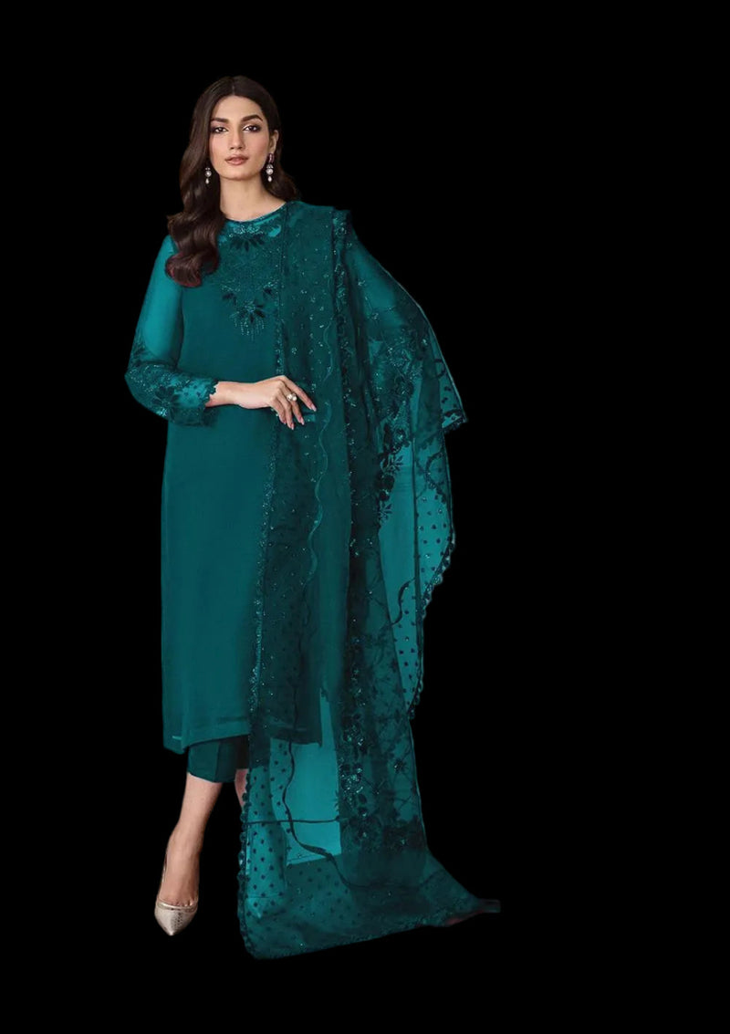 Woman wearing a teal embroidered saree with a matching blouse against a neutral background
