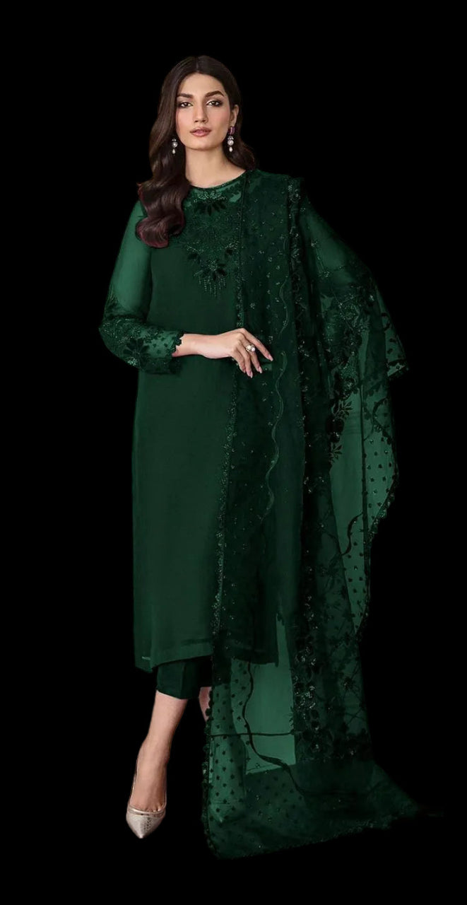 Woman wearing a dark green traditional outfit with a matching dupatta against a neutral background
